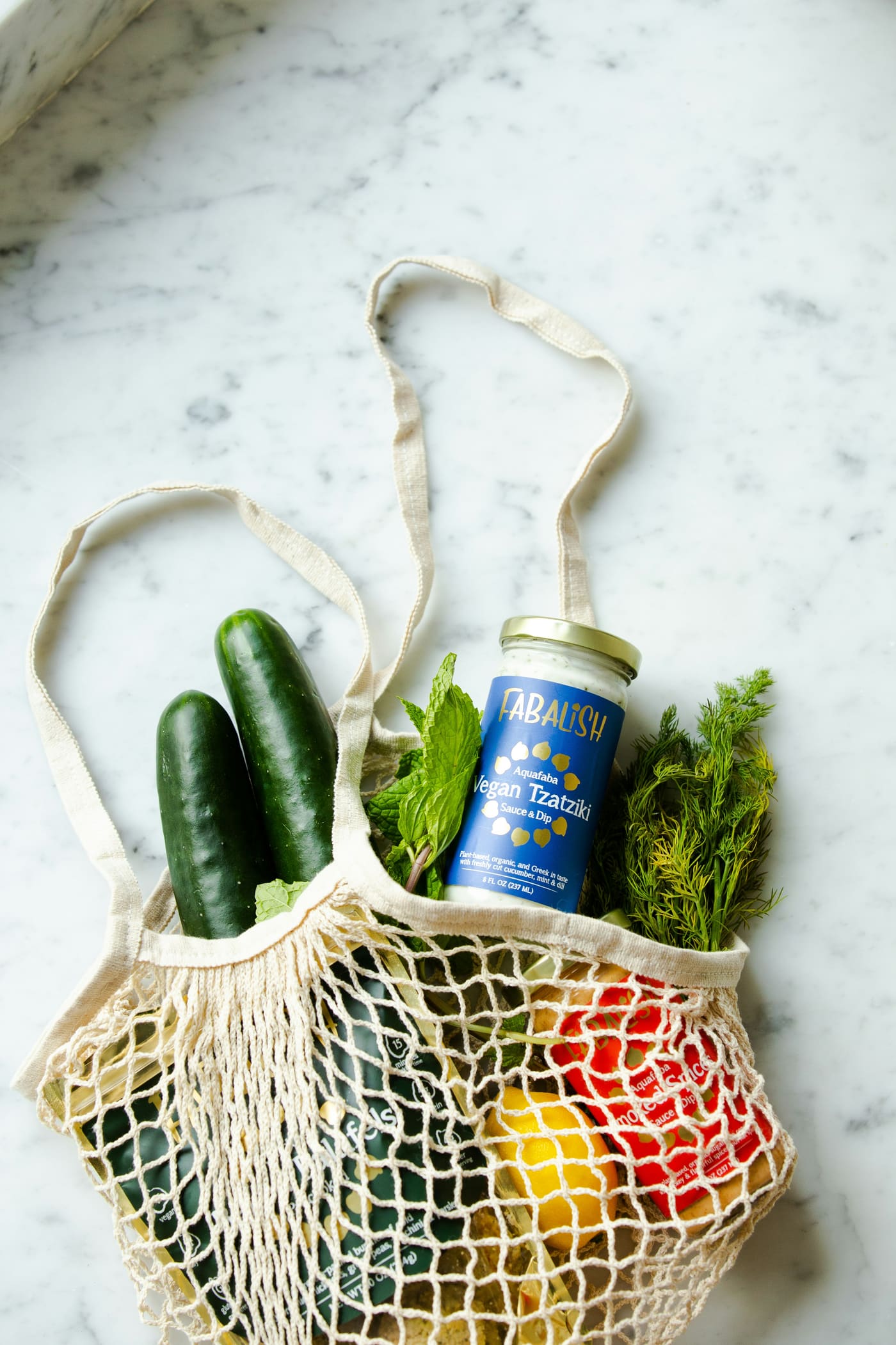 a cotton tote bag with vegetables and a labelled jar