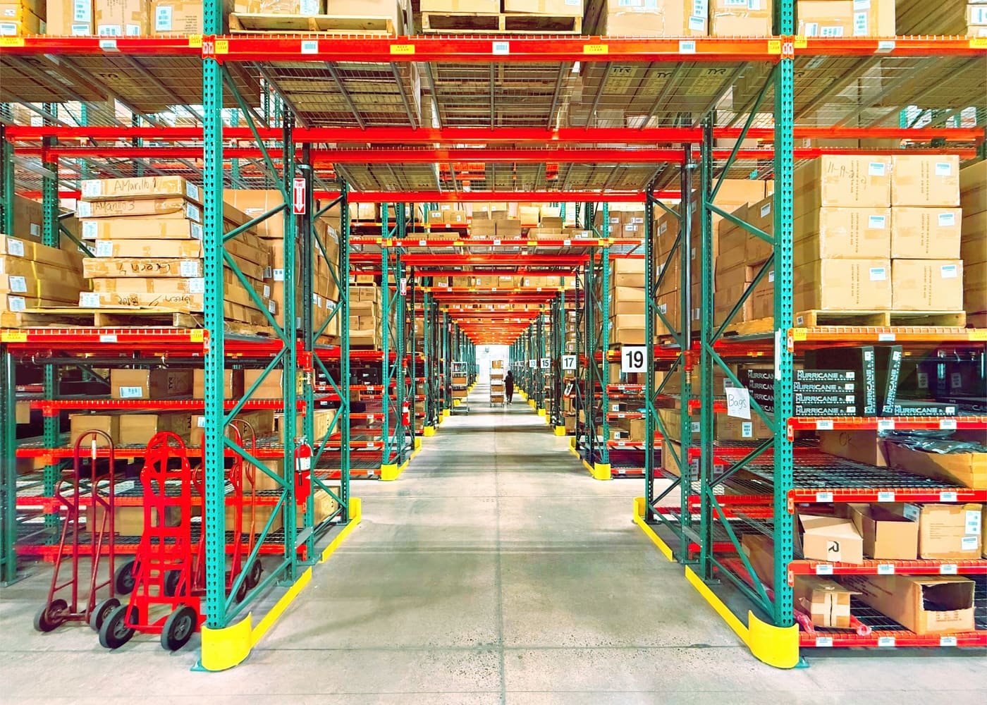 an aisle of pallet racks in a warehouse
