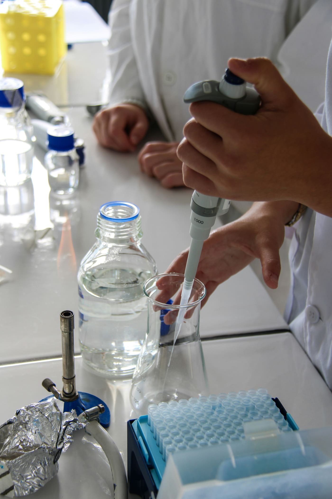 a pipette drawing a water sample on a laboratory bench