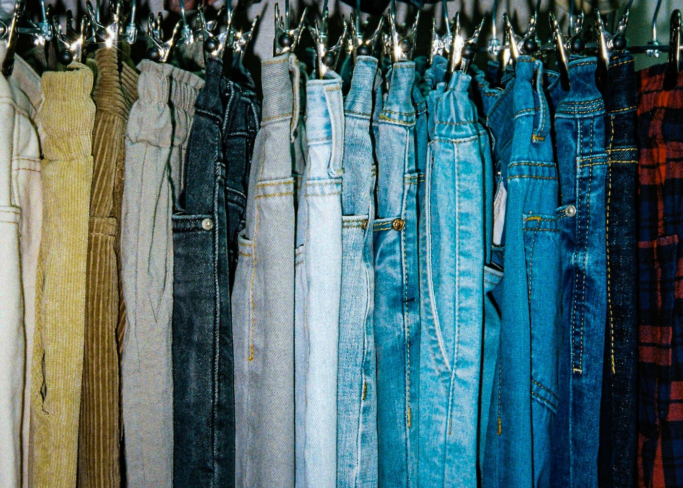a rack of jeans in shades of blue