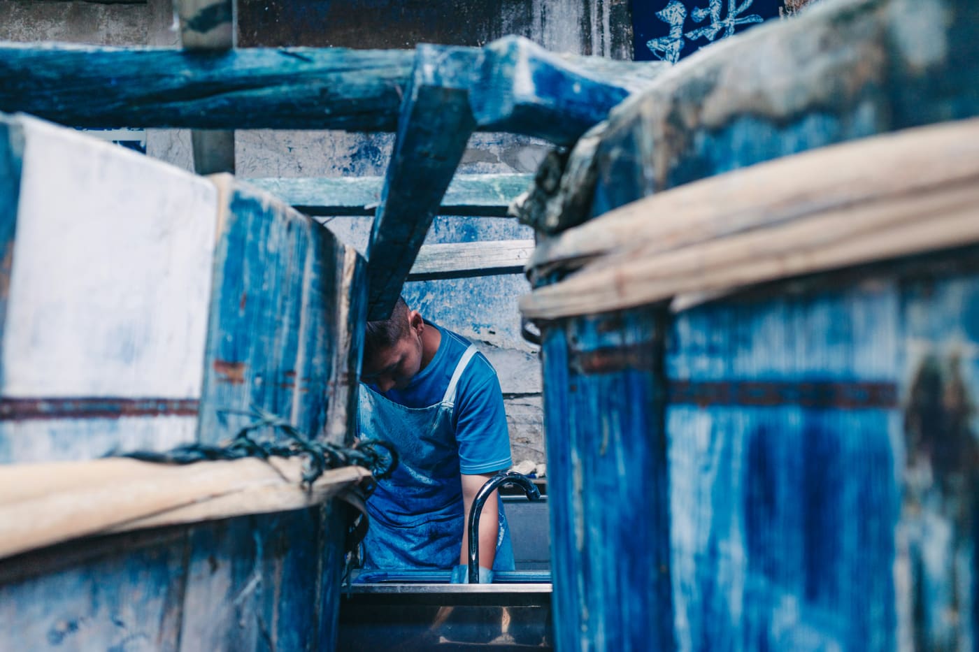 a worker at a vat in an indigo dye house