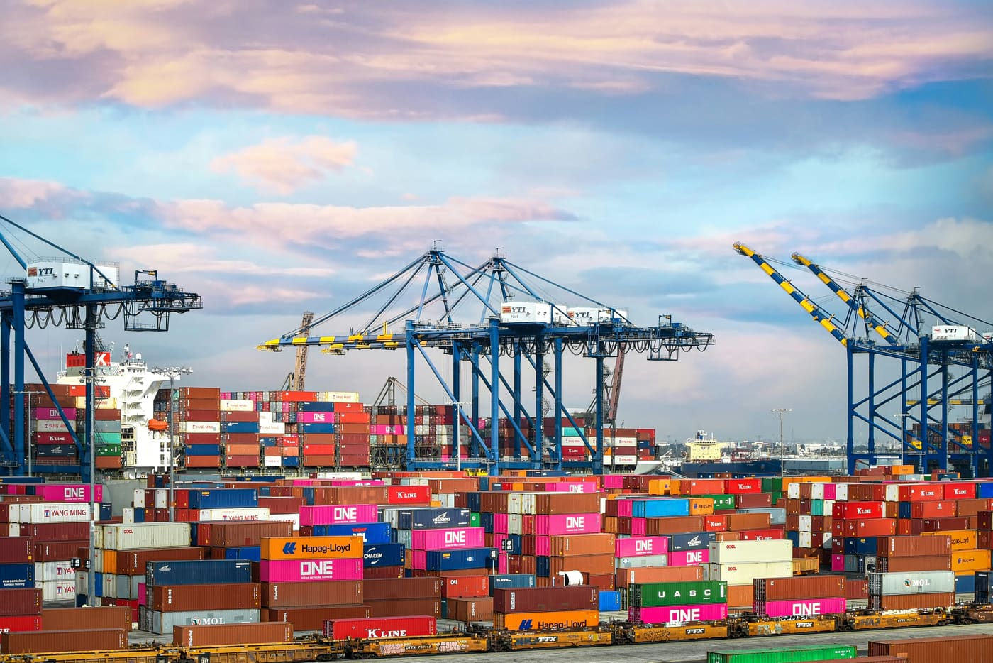 stacked containers and cranes at a port terminal